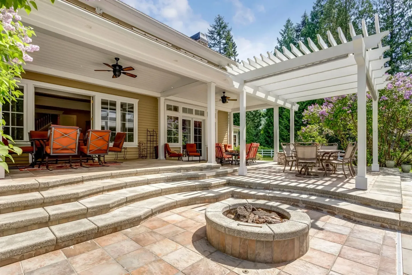 Spacious outdoor patio with fire pit and comfortable seating.